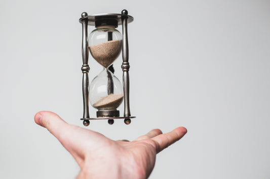 Hour glass above hands